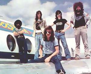 Boston with Tom Scholz (second from left) ... check out the  The perfectionist Scholz soon had his mates back in the studio to record a second album, but despite producing hit singles and going multi-platinum, there was always the feeling that Don t Look Back was a repeat performance of the first album. <br /><br />Fiercely independent, Scholz refused to allow himself to be pressured by Epic into rush-recording a third album. Instead, he formed a company called Scholz Research & Development to manufacture the signal-processing devices that he was designing for musical instruments. Through this company he became a multi-millionaire all over again, as his Rockman headphone amp and Power Soak monitors became state of the art! <br /><br />This wasn t thrilling to the record company, Boston s management and indeed some of Scholz s own band members. In fact it was then that legal troubles began to dog Scholz and Boston, as arguments over release schedules and royalties got out of control. Scholz spent most of the early 1980s extricating himself from this mess, and Goudreau and Delp recorded an album together. It wasn t until 1985 that Boston began recording its third album in earnest, and by this time Scholz and Delp were the only founder members left, although Masdea was recalled to replace Hashian. <br /><br />Defying those who maintain that lightning can t strike twice, Boston created yet another multi-platinum work with Third Stage. The chart-topping ballad Amanda became yet another instant evergreen, and while it was arguable that Boston was just churning out watered-down versions of the same album over and over again, there was clearly an audience of millions willing to lap up the stuff. <br /><br />And still the troubles persisted. Inter-band royalty clashes were now the order of the day, with Scholz being sued by not just Hashian but Masdea as well! <br />Still, it was hard for his band-mates to portray Scholz as the villain of the piece while the man actively pursued a variety of noble causes. Aside from anti-drug and pro-vegetarian campaigns, Scholz actually set up a foundation supporting animal rights and helping to 																																																																																																																																																																																																																																																																																																												<a href=